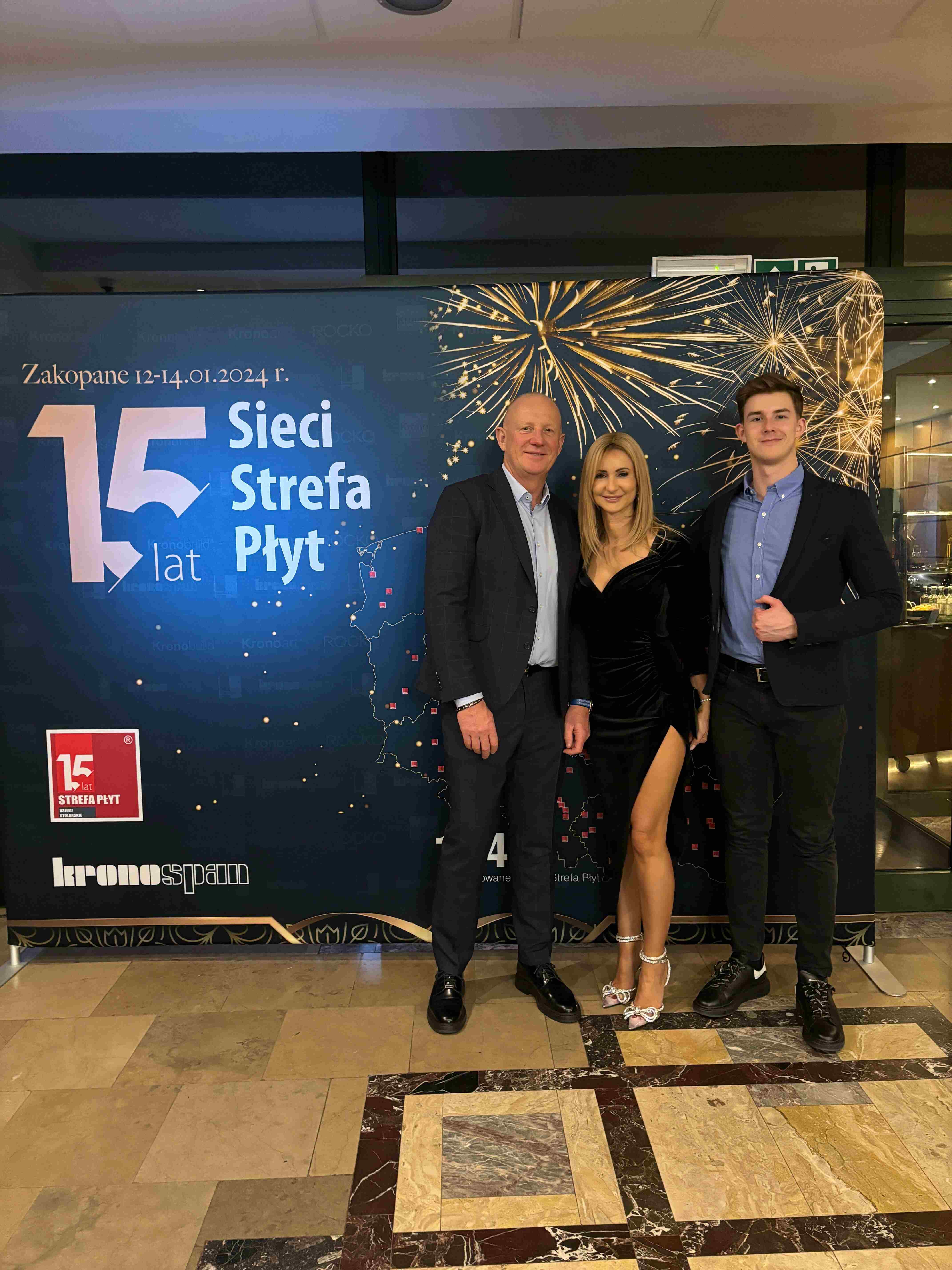 Kacper with parents at Kronospan event